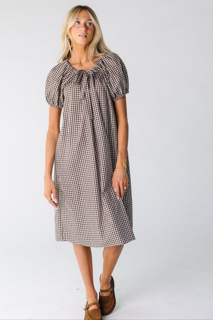 Modest woman's brown gingham midi dress with short sleeves