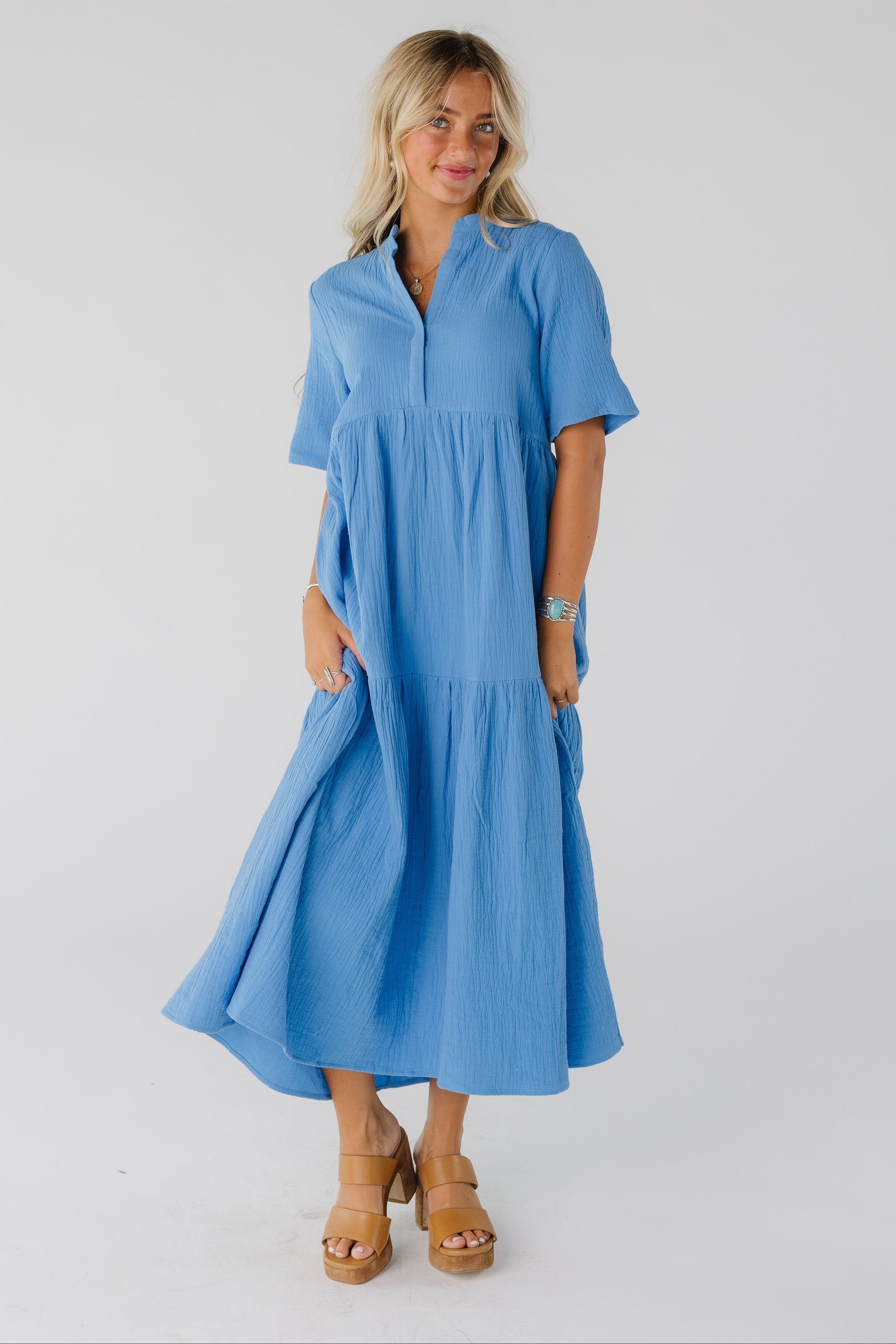 Woman wearing blue textured midi dress with short sleeves