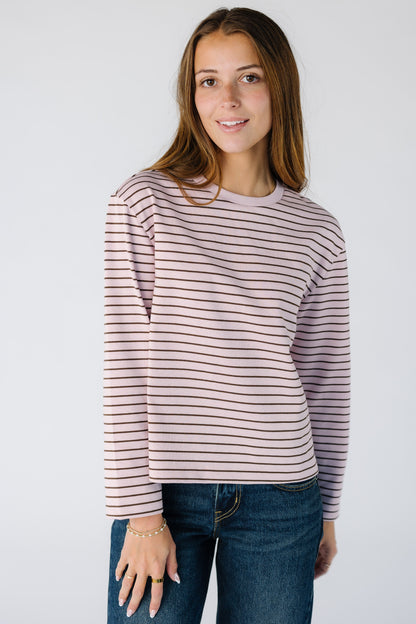 Woman wearing a long sleeve stripe tee in a pink with brown stripe