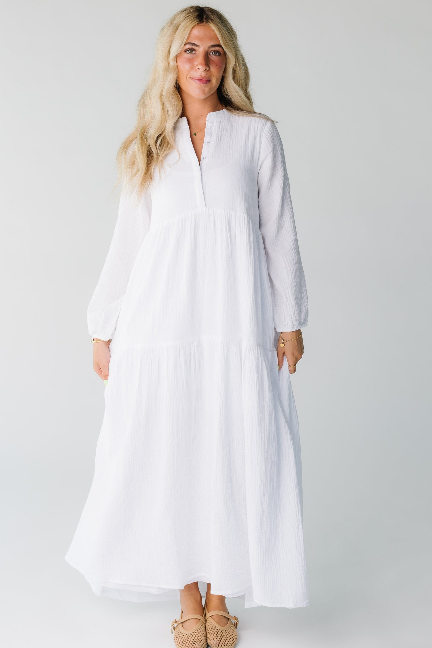 Modest women's white maxi dress with V-neckline and long sleeves