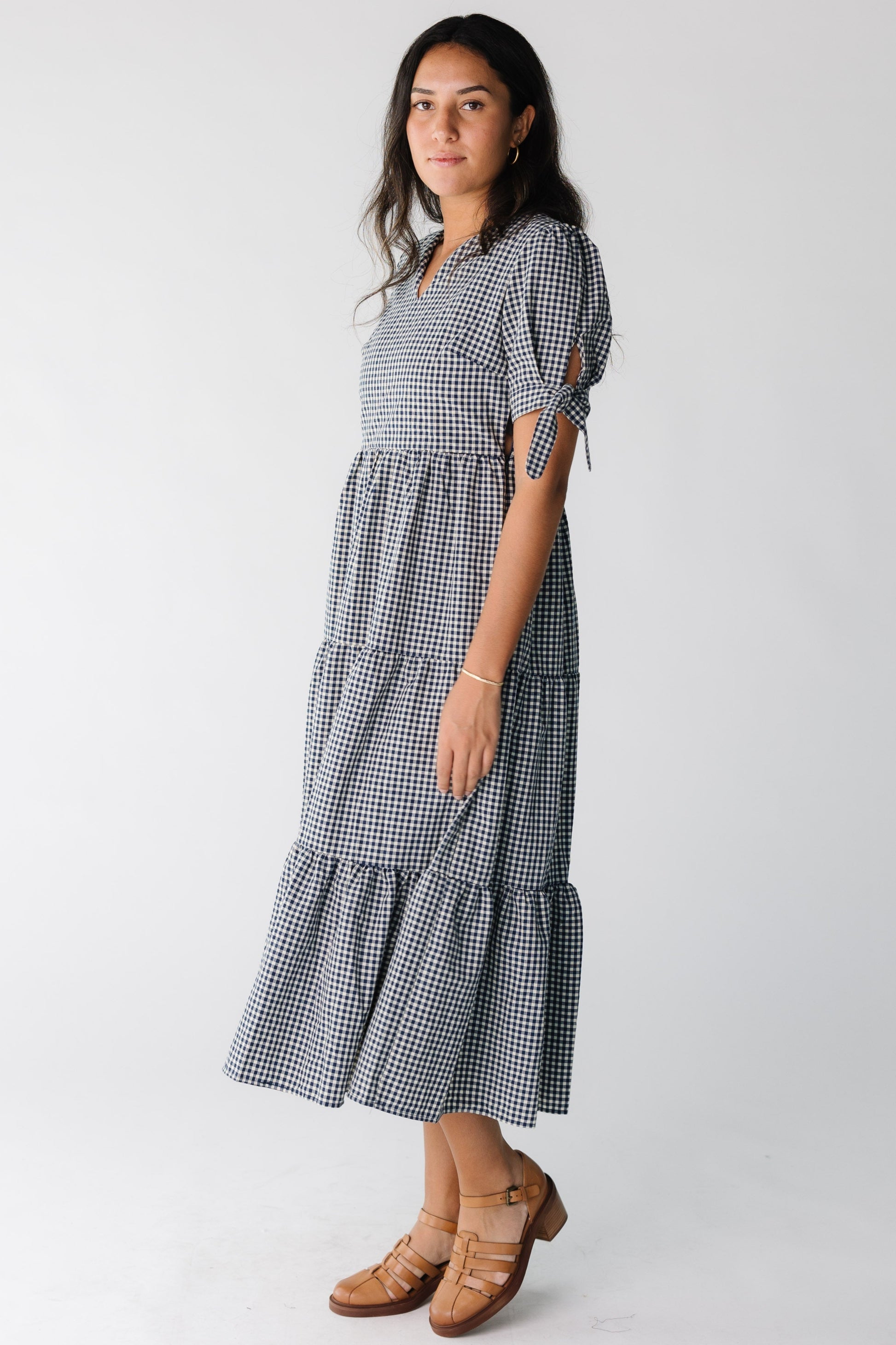 Woman wearing a blue gingham midi dress with short sleeves