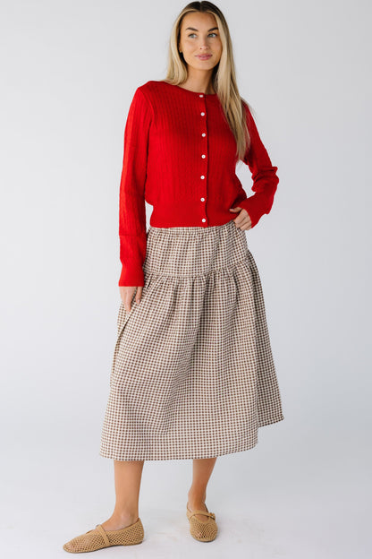 Woman wearing a drop waist midi skirt in brown and cream gingham