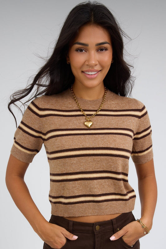 Young woman wearing a light brown stripe, lightweight stripe sweater with a round ribbed necklie and short sleeves.