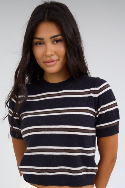 Young woman wearing a modest navy,brown & white stripe sweater with a round neckline and short sleeves. 