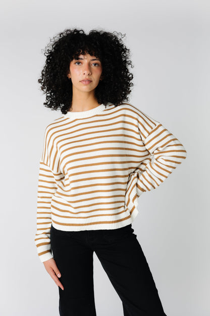 Loose fitting cream sweater with cinnamon brown stripes and crew neckline