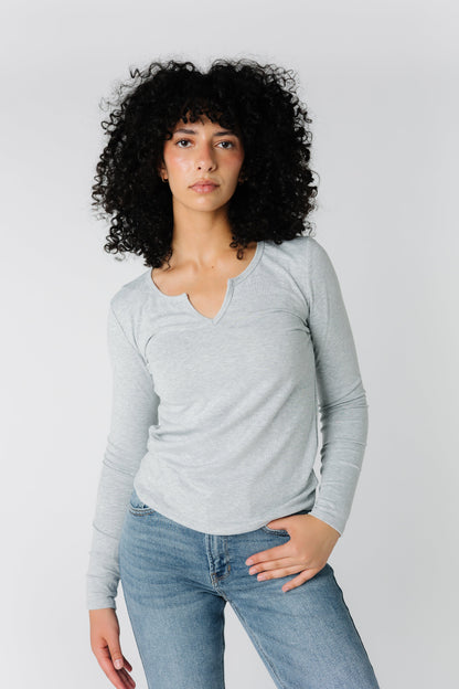 Light grey top with notched neckline and long sleeves