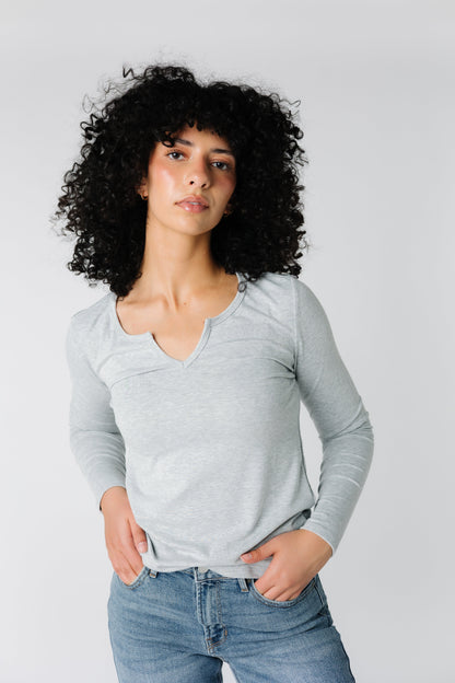 Light grey close fitting ribbed top with notched neckline and long sleeves