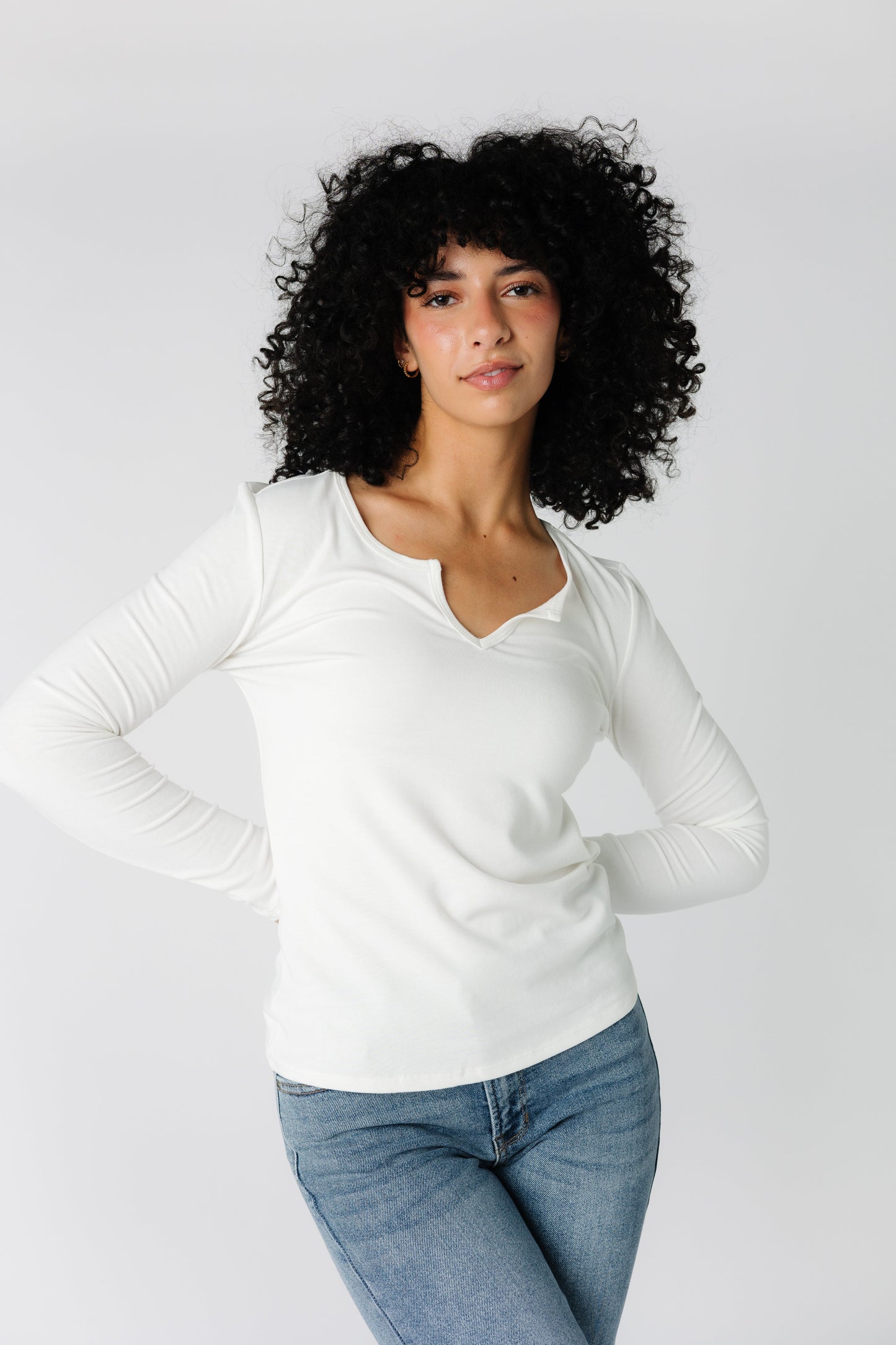 Rib knit top with close fitting long sleeves and notched front neckline