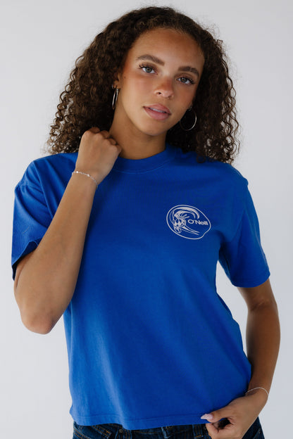 Young woman wearing a royal blue short sleeve tee with a small front white graphic.