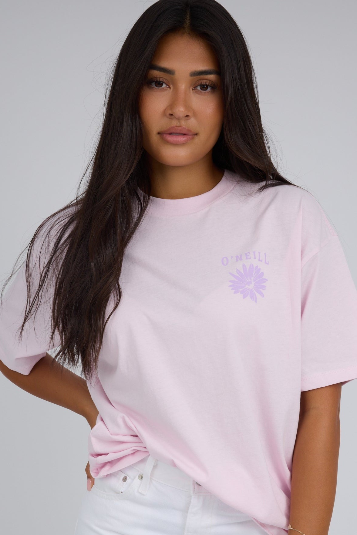 Woman wearing a modest light pink short sleeves with a crew neckline nad short sleeves.