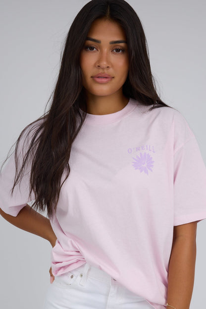 Woman wearing a modest light pink short sleeves with a crew neckline nad short sleeves.