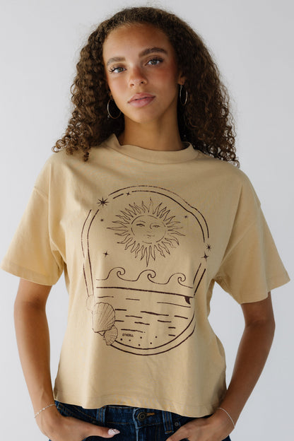 Young Woman wearing a modest yellow graphic tee with a crew neckline and short sleeves.