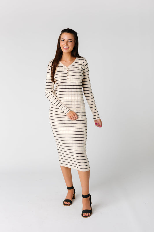 Close fitting cream sweater dress with narrow black stripes