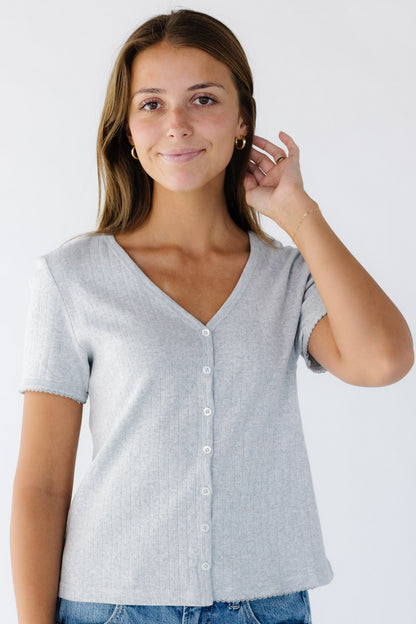 Woman wearing a modest pointelle V-neck button down  top in heather grey.