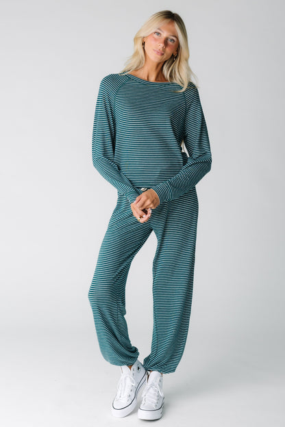 Modest green  lounge top worn by a woman with long sleeves and round neckline