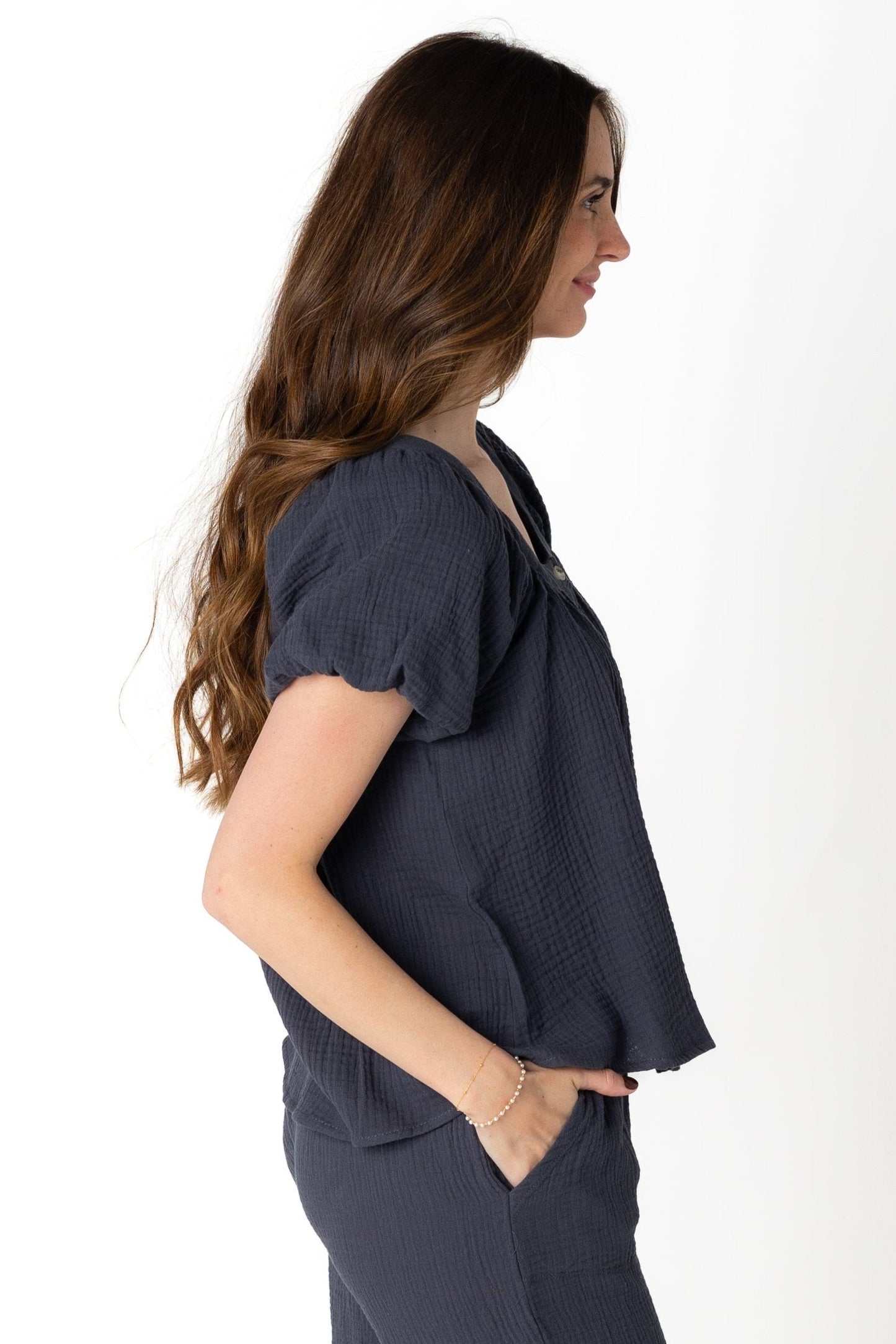 Side view of gauzy charcoal top with short puff sleeves