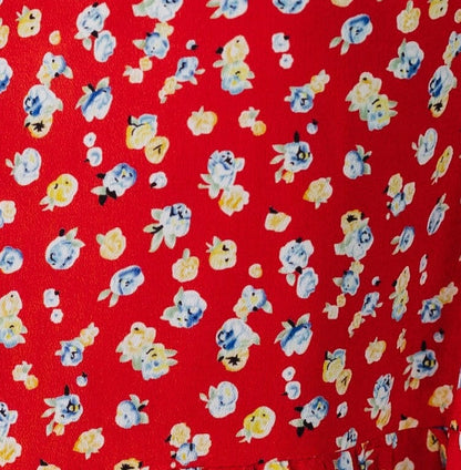 Red floral print fabric swatch.