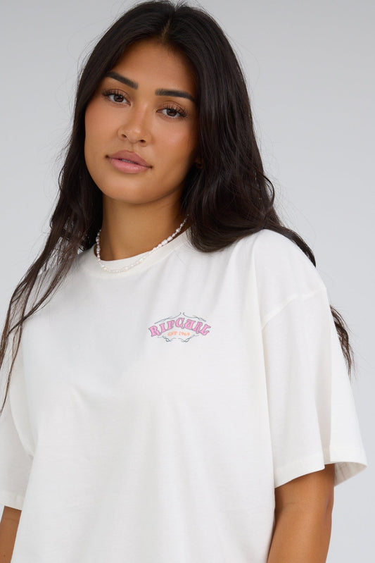 Young woman wearing a modest white graphic tee with short sleeves.