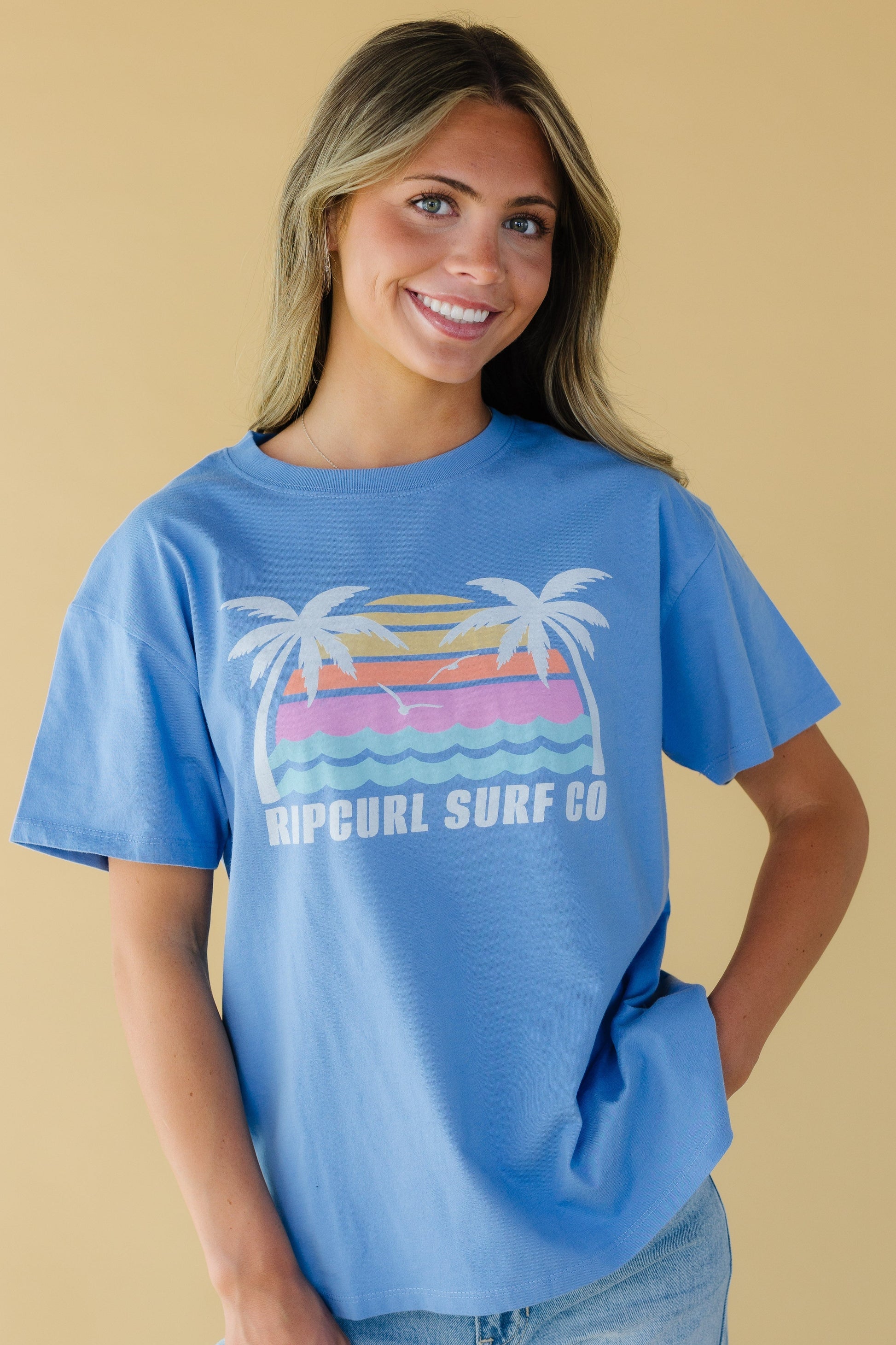 Young woman wearing a blue graphic tee with a crew neckline and short sleeves.