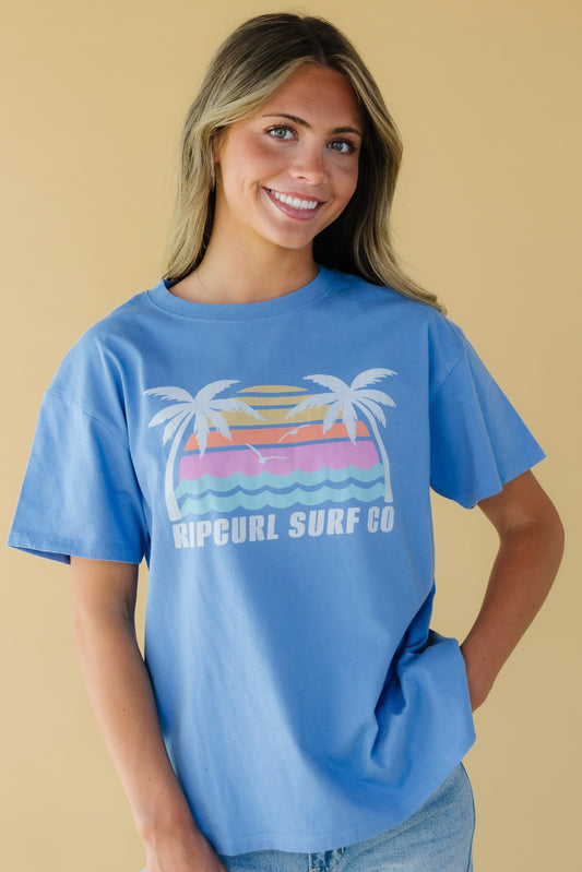 Young woman wearing a blue graphic tee with a crew neckline and short sleeves.