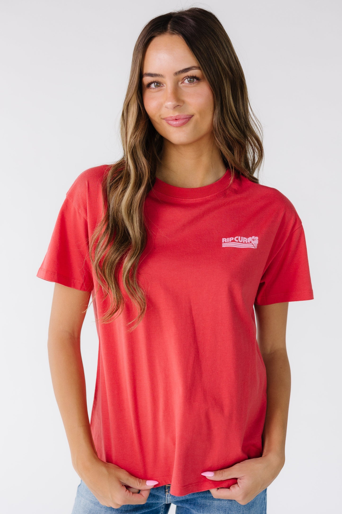 Woman wearing a modest red short sleeve graphic tee with a crew neckline, short sleeves and a crew neckline.