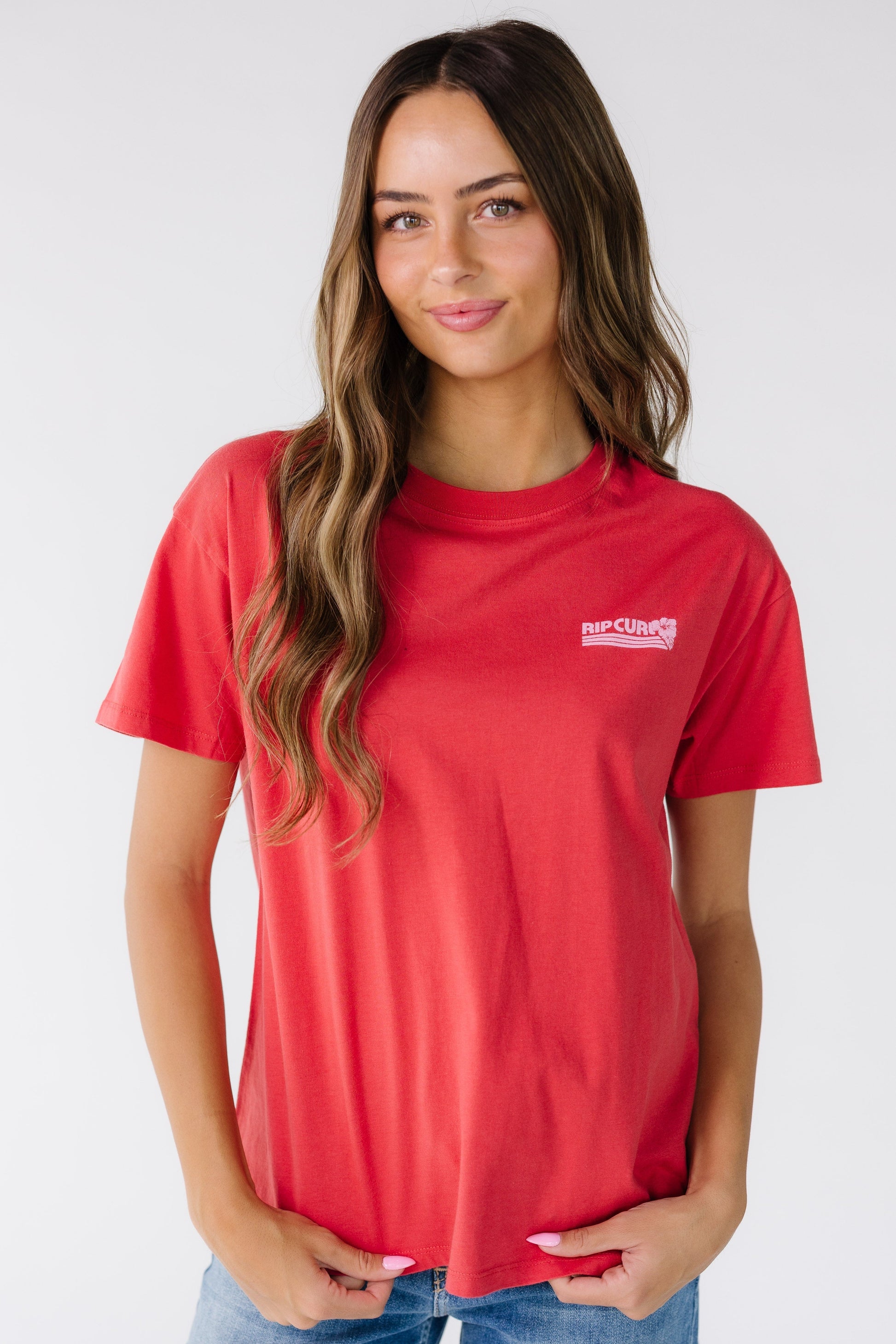 Woman wearing a modest red short sleeve graphic tee with a crew neckline, short sleeves and a crew neckline.