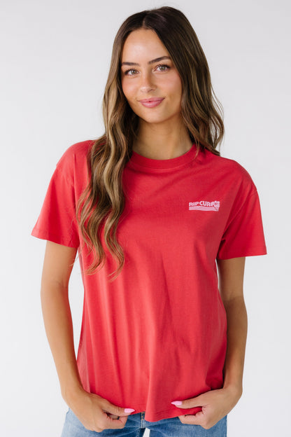 Woman wearing a modest red short sleeve graphic tee with a crew neckline, short sleeves and a crew neckline.