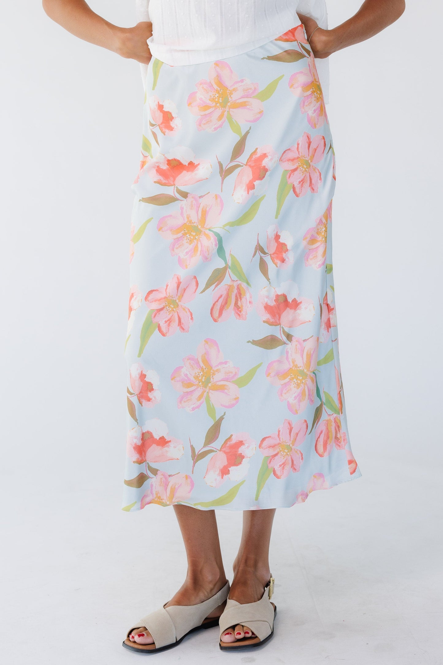 Young woman wearing a modest blue floral A-line print midi skirt.