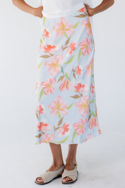 Young woman wearing a modest blue floral A-line print midi skirt.
