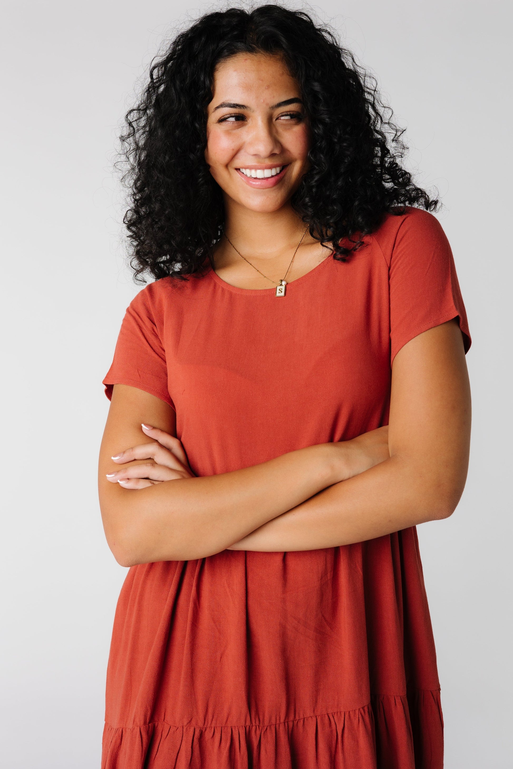 Close view of rust dress with wide round neckline with short sleeves