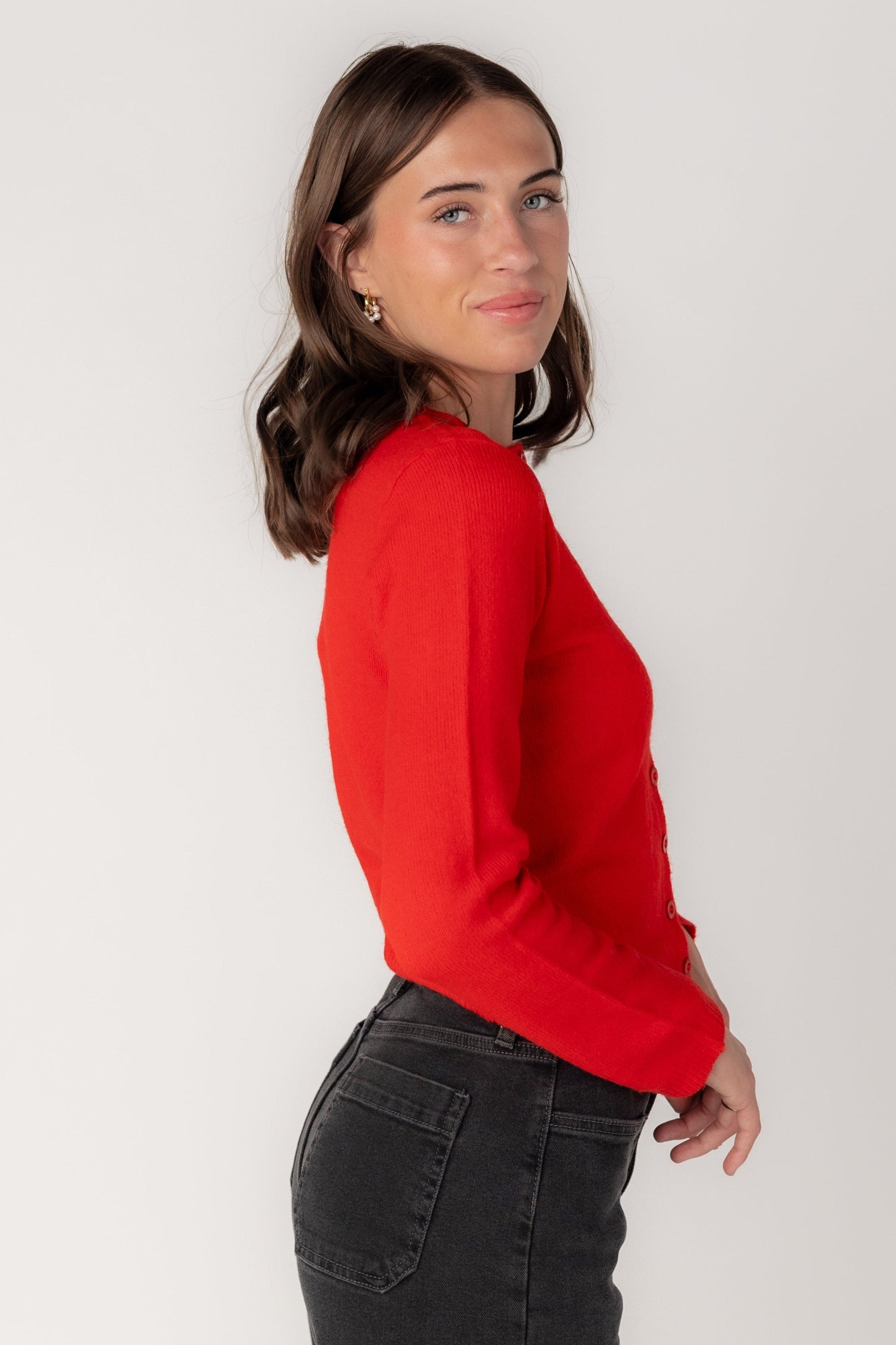 Side view of long sleeve red cardigan