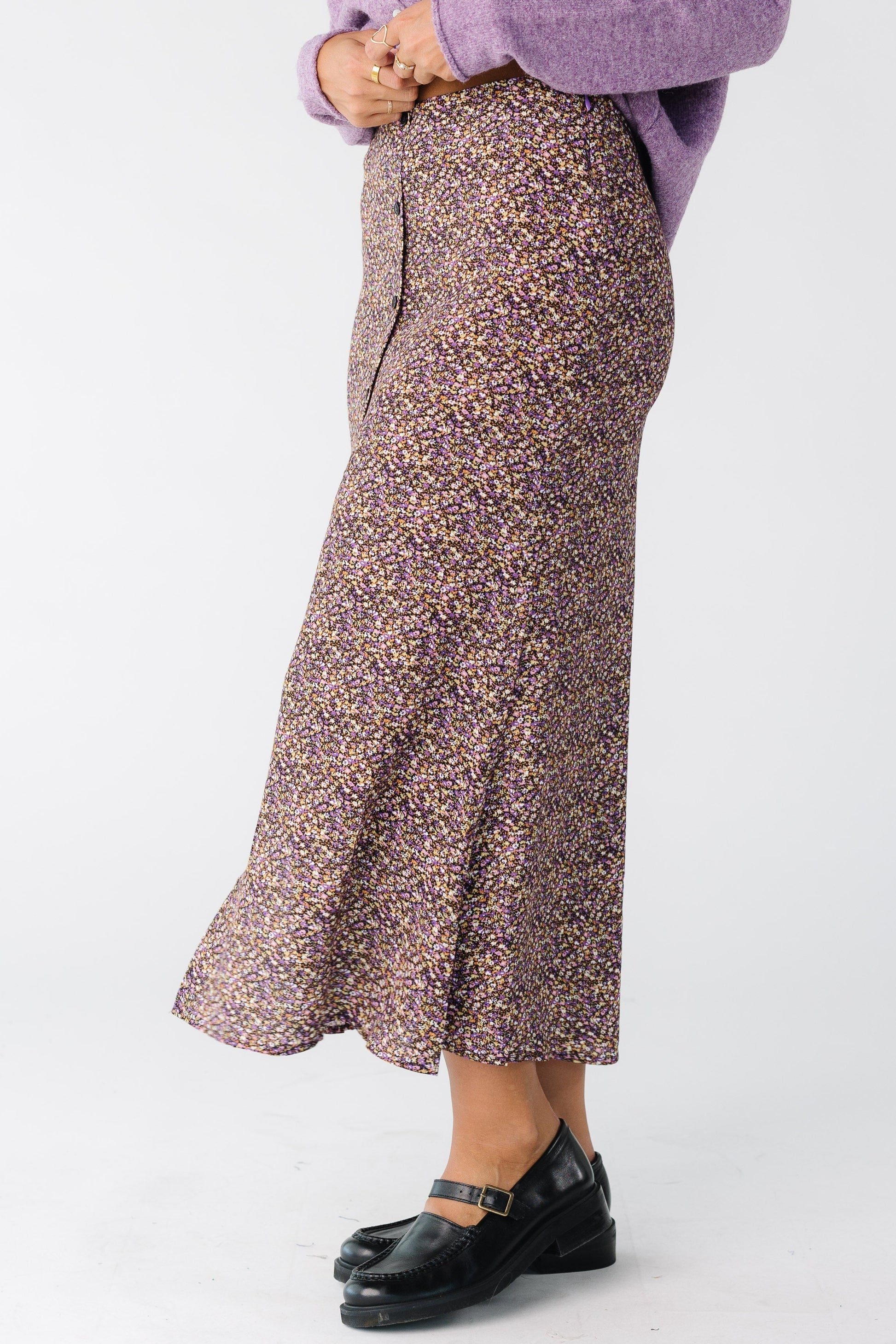 Side view of a floral print midi skirt with faux button placket