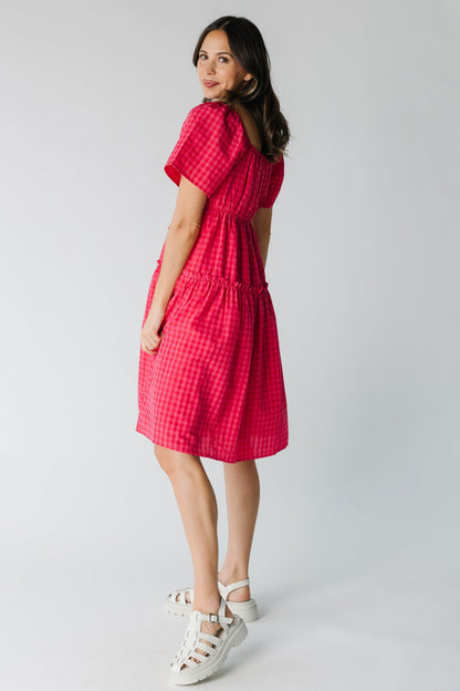 Side view of fuchsia gingham dress with short sleeves