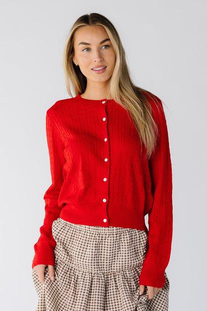 Woman wearing a long sleeve cardigan in red with a round neckline