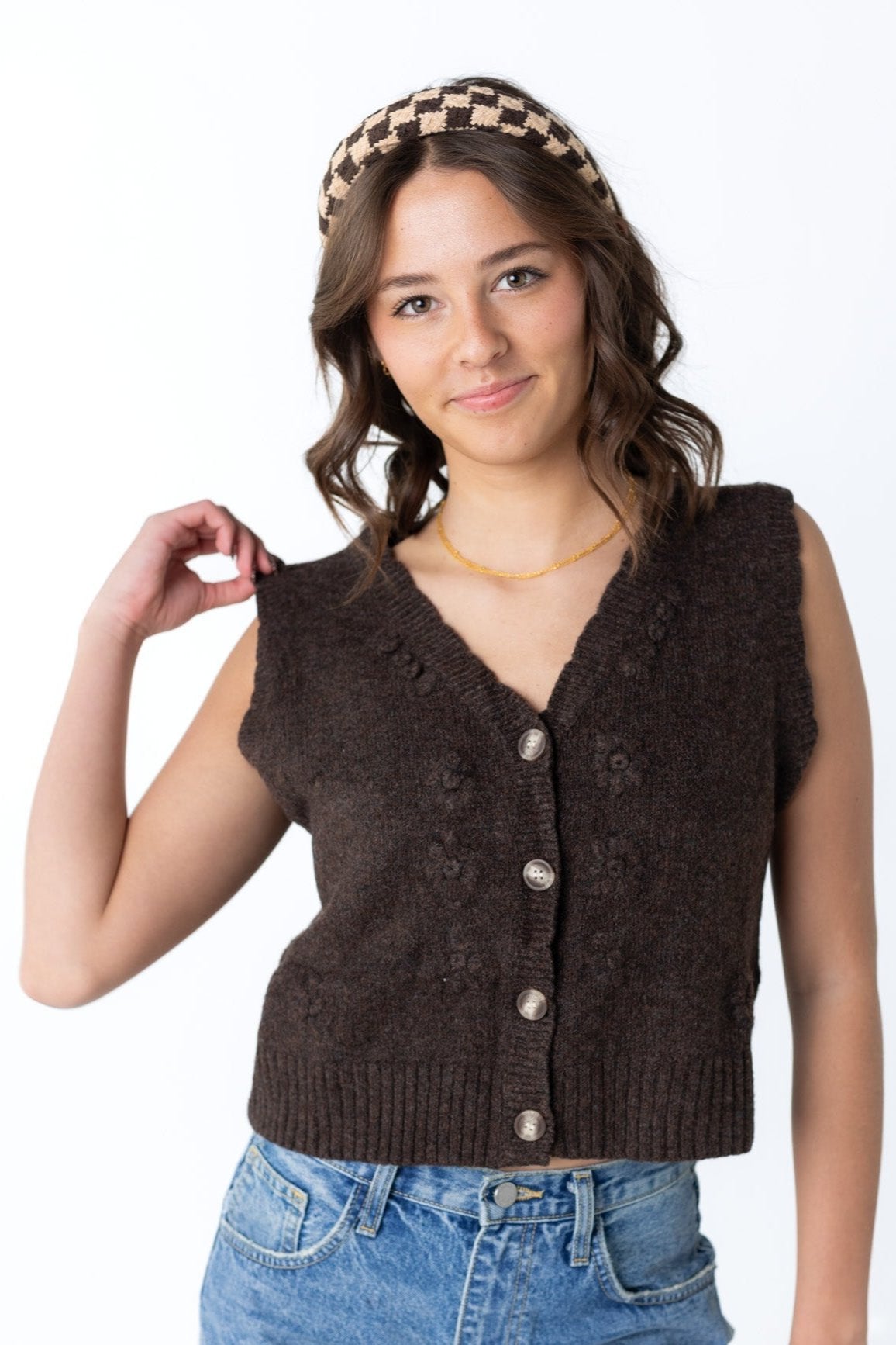 Dark brown sleeveless sweater vest with V-neckline