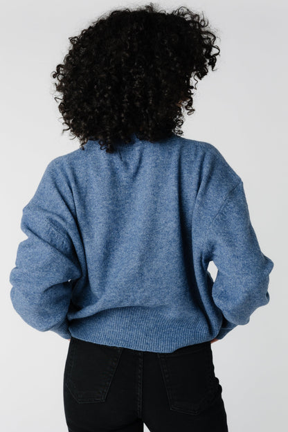 Back view of heather blue loose fitting sweater