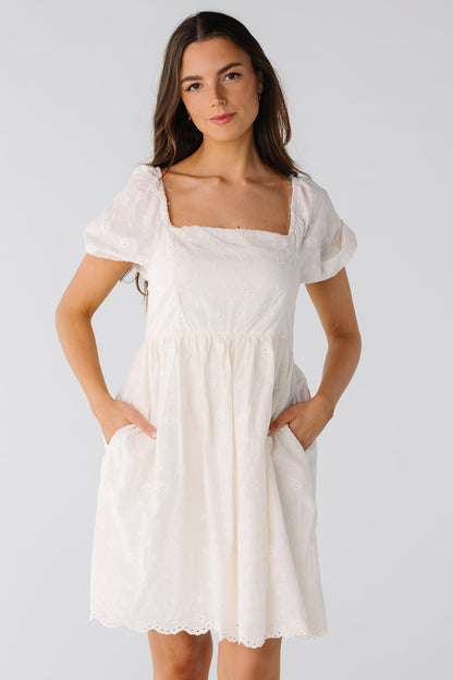 Square neck eyelet dress with short puff sleeves and side pockets