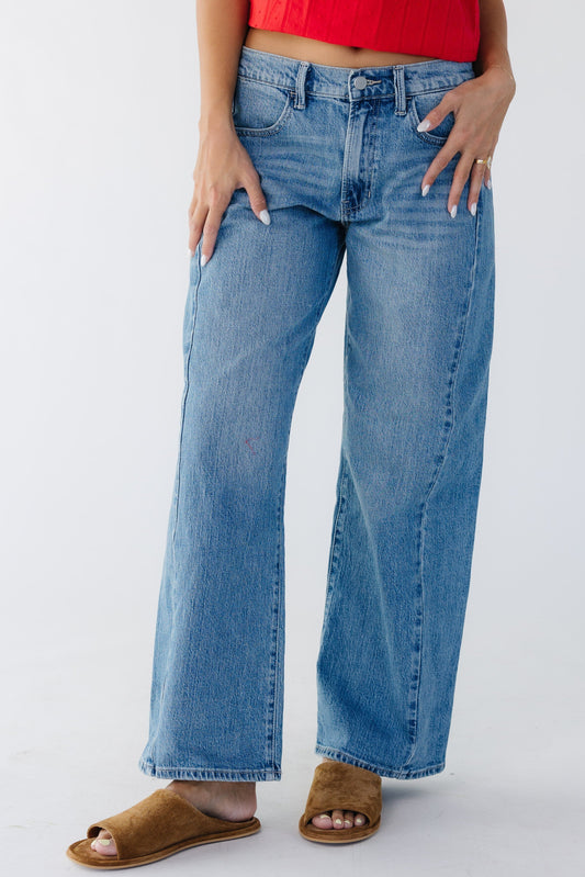 Young woman wearing modest wide leg jeans with a side panel . 