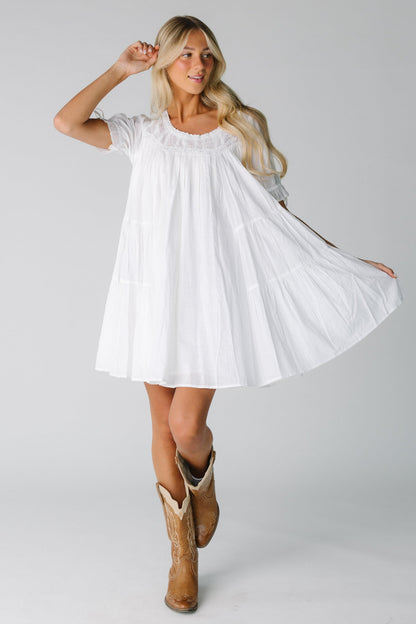 Modest white knee length dress with round neckline and short sleeves