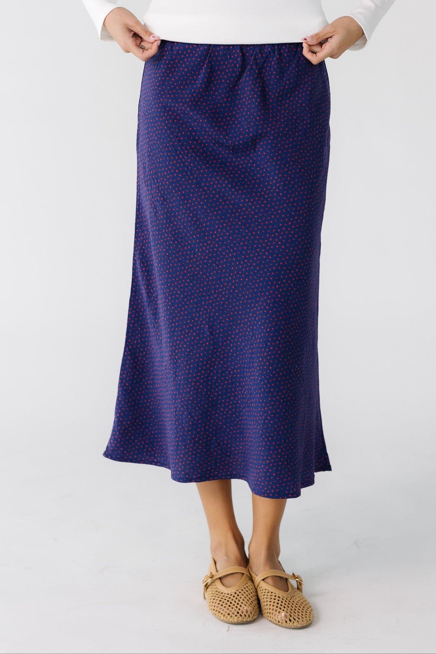 Teen girl wearing a purple print A-line skirt.