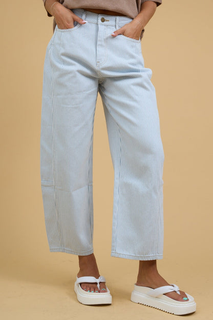 Young woman wearing modest white & blue wide leg barrel pants with a button and zipper closure.