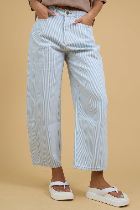 Young woman wearing modest white & blue wide leg barrel pants with a button and zipper closure.