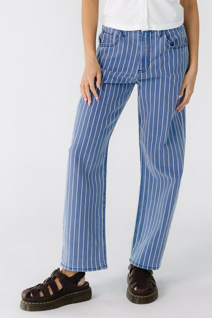 Teenage girl wearing a navy and white stripe barrel jeans.