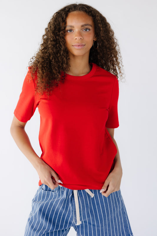 Teenage girl wearing a modest red classic t-shirt.