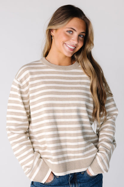 Woman wearing a modest long sleeve sweater in beige and ivory