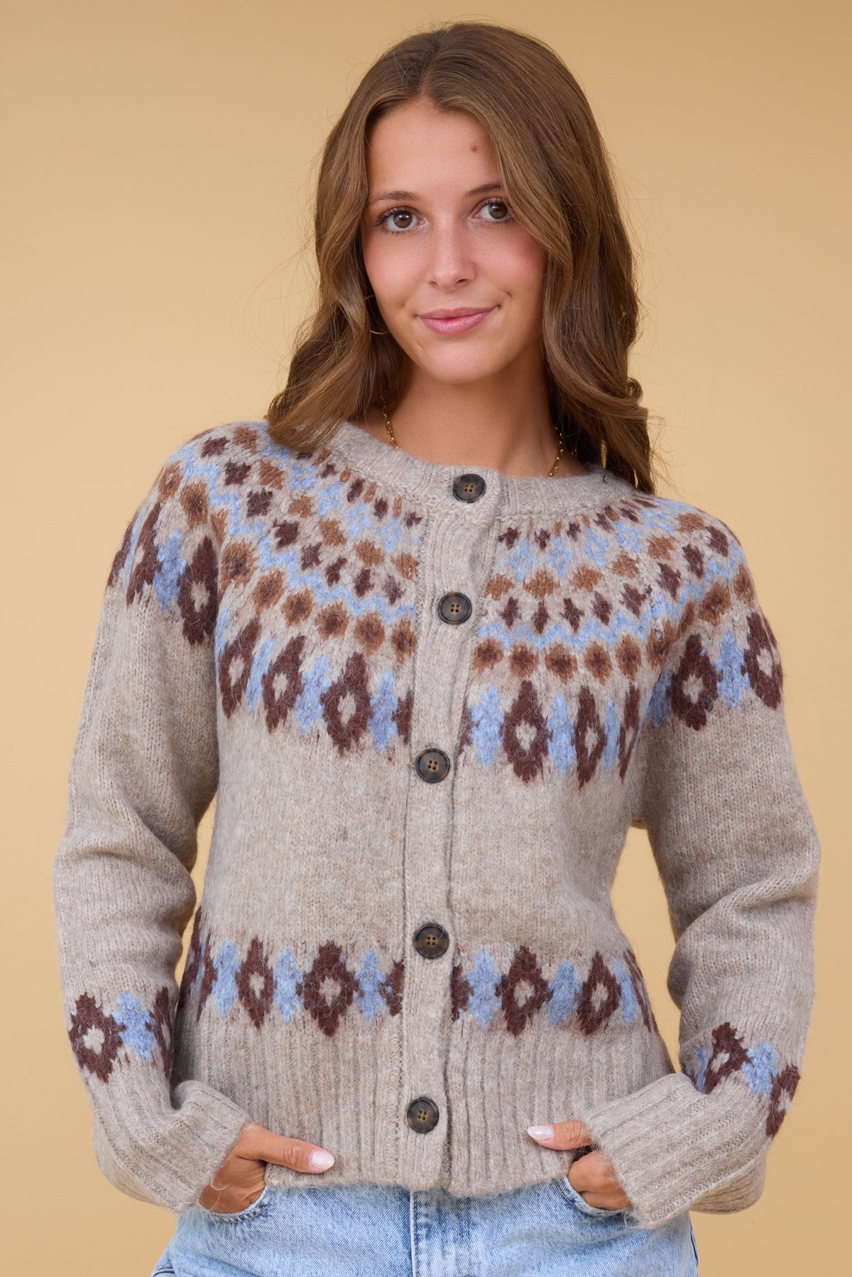 The Davis Cardigan in beige with a blue & brown nordic pattern for women & teen girls.