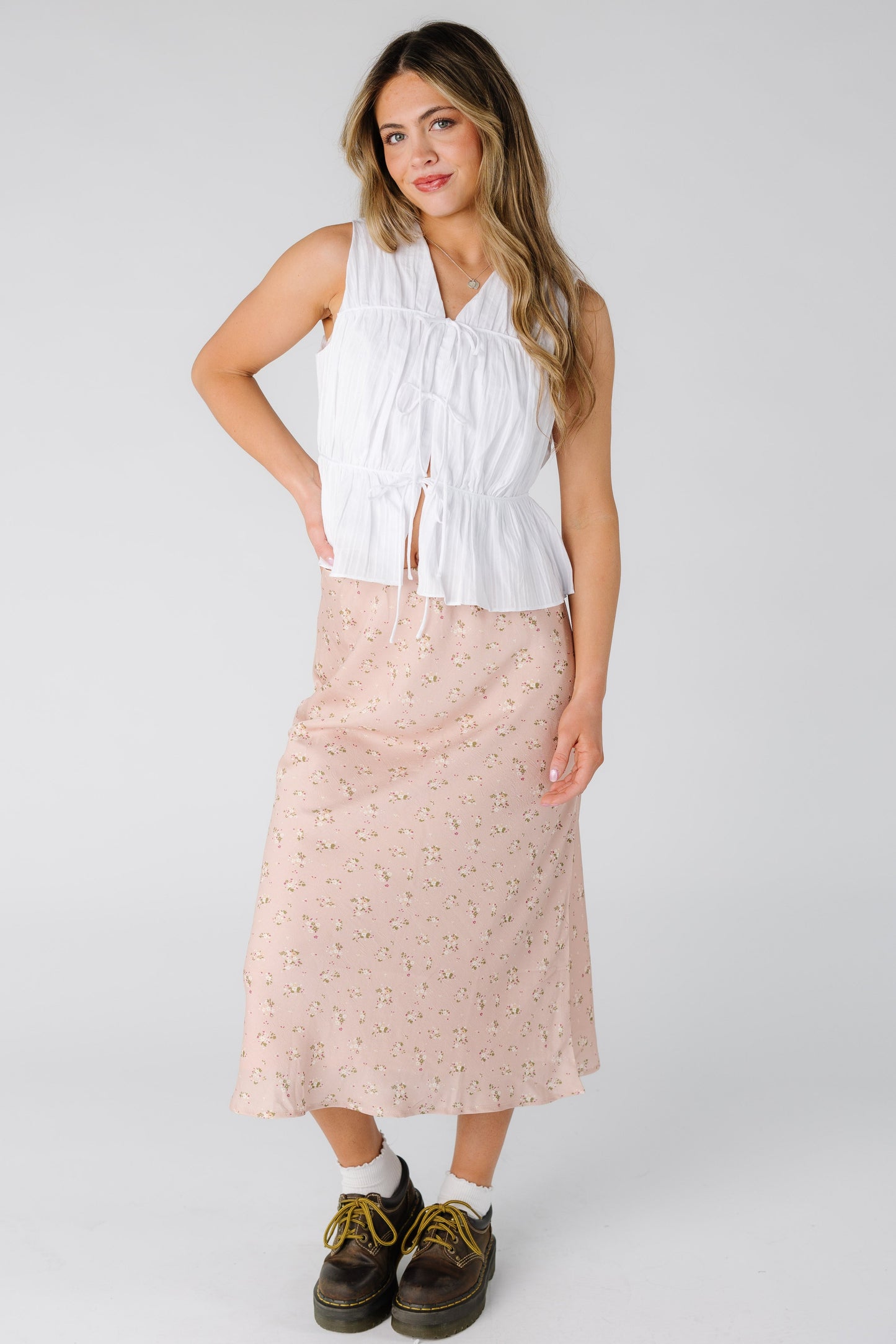Woman wearing a modest pink floral midi skirt 