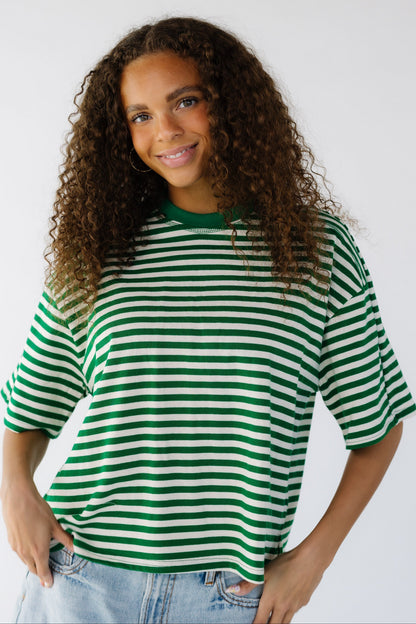 Teen girl in a modest green and white stripe tee with short sleeves.