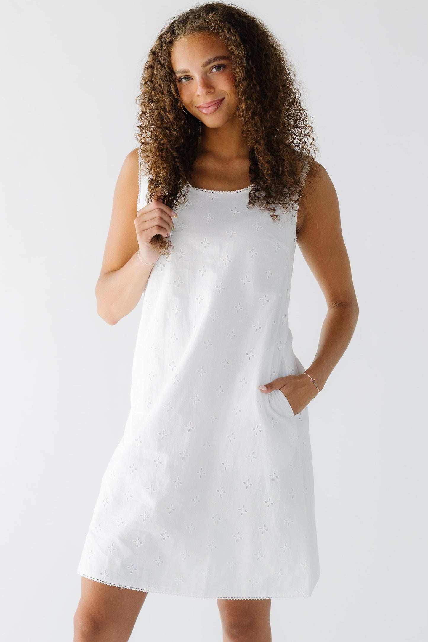 The Tessa Dress in all white eyelet knee length dress.