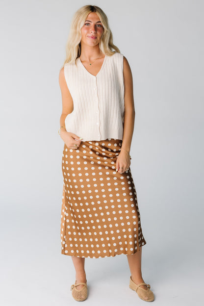 Woman wearing cream ribbed sweater vest with V-neckline 